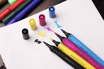 Brush Colouring Pens On Top Of White Paper