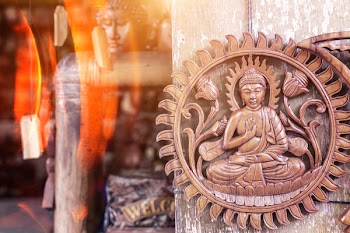Buddha Brown Wooden Wall Decor Hanging on Gray Surface