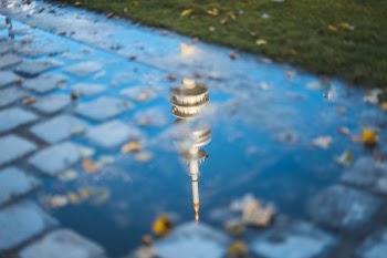 building reflected on puddle