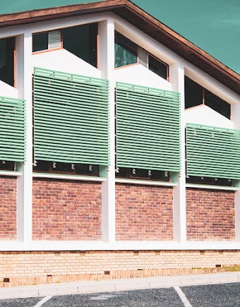 Building With Brickwall and Green Railings