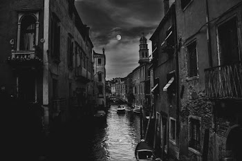 buildings and river with boat