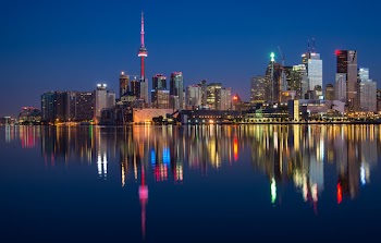 Buildings Near Body Of Water At Night 