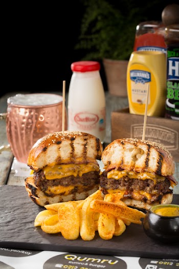 Bun With Grilled Meat and Cheese on Black Surface