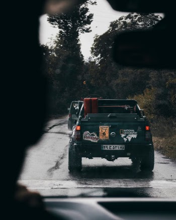 bunch of trucks driving in a rainy day
