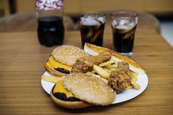 Burger and Fried Potatoes on Plate