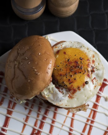 Burger With Sunny-side Up on White Surface