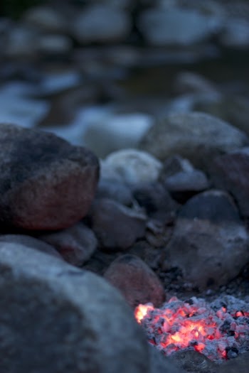 Burning Firelog Surrounded of Pebbles