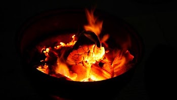Burning wood and orange coals in a fire