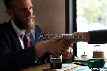 Business agreement handshake at coffee shop