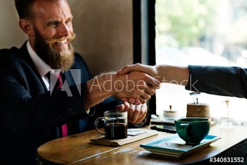 Business agreement handshake at coffee shop