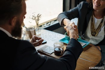 Business agreement handshake at coffee shop