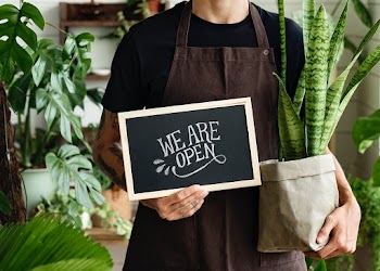 Business owner holding we are open sign | Free stock photo | High Resolution image