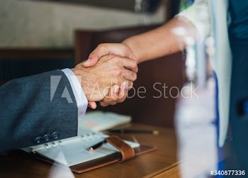 Business partners shaking hands in agreement