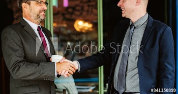 Business partners shaking hands in agreement