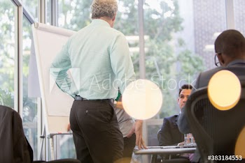 Business people brainstorming with flipchart in conference room meeting