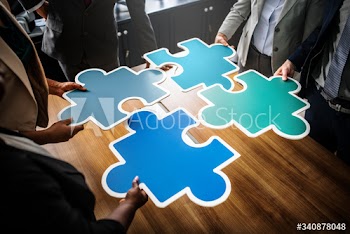 Business people connecting puzzle pieces