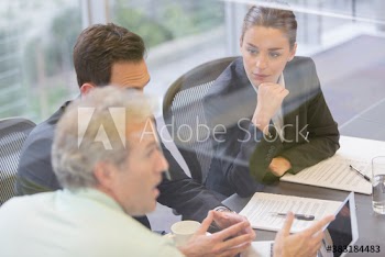 Business people discussing paperwork in conference room meeting