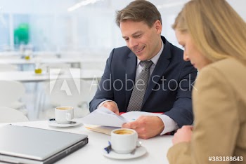 Business people discussing paperwork in office