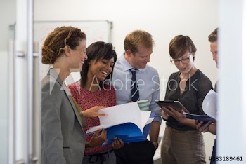 Business people discussing paperwork in office