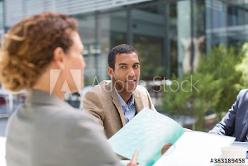 Business people discussing paperwork outside