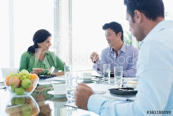 Business people eating sushi lunch during meeting