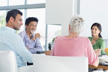 Business people enjoying sushi lunch during meeting