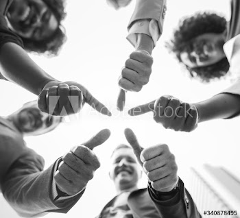 Business people giving a thumbs up
