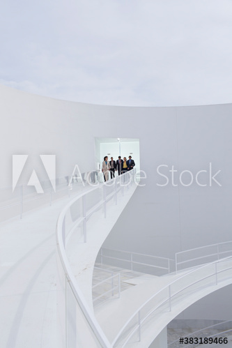 Business people in doorway of modern courtyard balcony