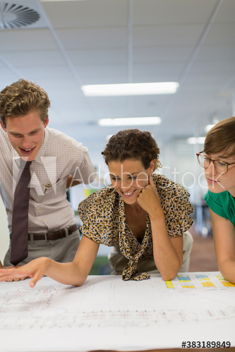 Business people looking at blueprint