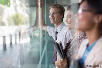 Business people looking out window