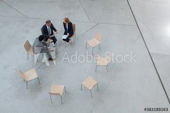 Business people meeting in circle of chairs