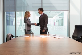 Business people shaking hands in conference room