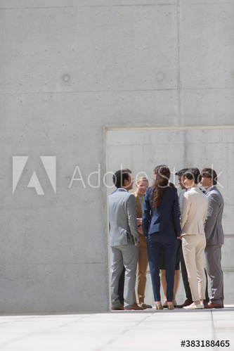 Business people talking in circle in patio doorway