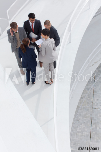 Business people talking in circle on ramp