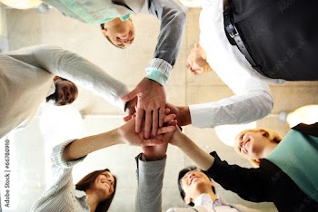 business people teamwork in an office with hands together
