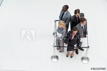 Business people trapped in square stanchions