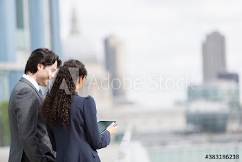 Business people using digital tablet in city
