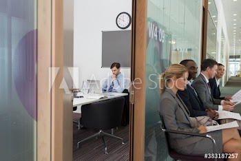 Business people waiting for job interview in office corridor