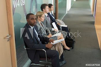 Business people waiting for job interview in office corridor