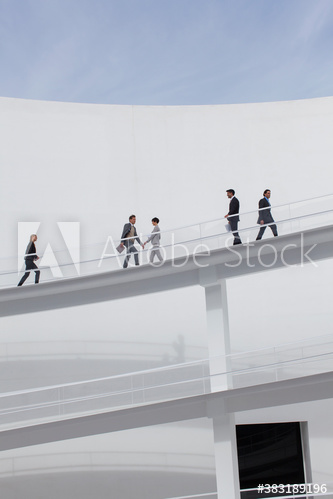 Business people walking on modern courtyard balcony