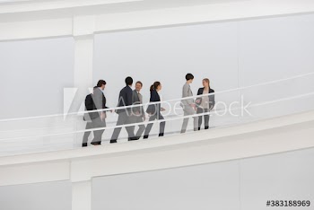 Business people walking on modern ramp