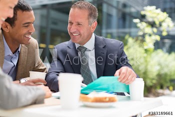 Business people with coffee meeting at table outdoors