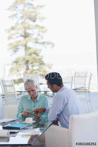 Business people with digital tablet talking