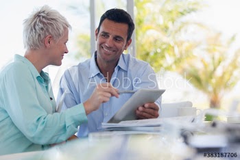 Business people with digital tablet talking in meeting