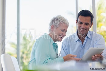 Business people with digital tablet talking in meeting