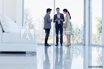 Business people with digital tablet talking in modern office