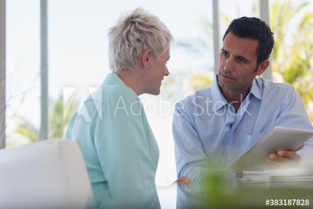 Business people with digital tablet talking in office