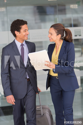 Business people with suitcase talking in office