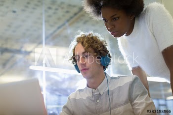 Business people working at laptop in office