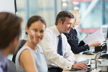Business people working in open plan office